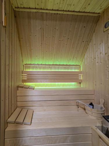 a wooden sauna with a green light in it at Nale Luxury Chalet in Bratunac