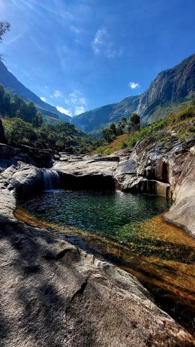 a small pool of water in a river with a waterfall at Mulanje Vista House in Mulanje