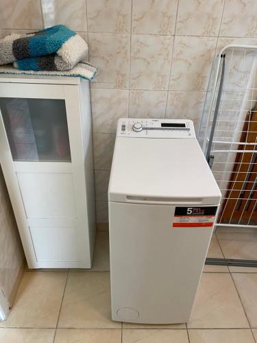 a small white refrigerator next to a white cabinet at Chalupa Klára 