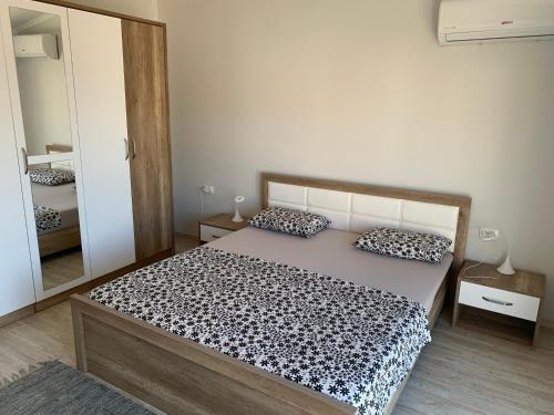a bedroom with a bed and a large mirror at Villa DanDan Sutomore in Zagrađe