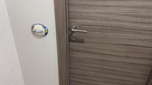 a wooden door with a metal door knob at Coast To Coast - Rooms & Pool! Camere moderne e piscina in Sant'Egidio del Monte Albino