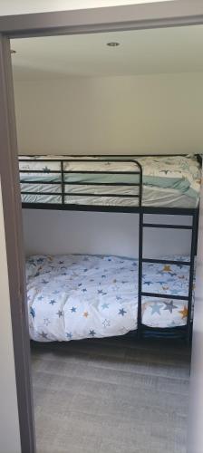 un lit superposé dans une chambre avec une étagère inférieure dans l'établissement appartement La Plagne Montalbert, à La Celle-sous-Gouzon