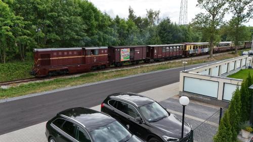 a car parked on the side of a road next to a train at Rafa in Trzęsacz