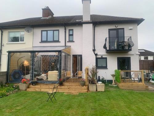 a house with a large deck in the yard at Private Studio near Dublin City in Dublin