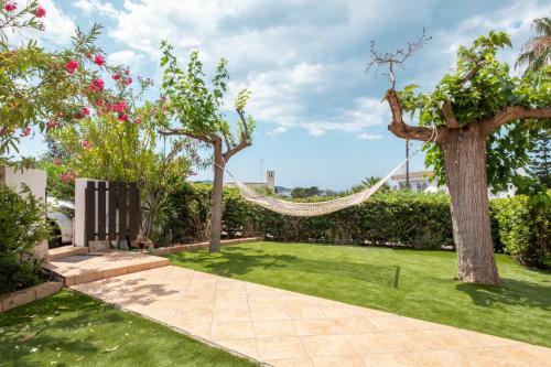 a hammock in a garden with trees and grass at Villa Vinci in Campu Longu
