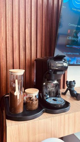 a coffee maker and containers on a counter with a coffee pot at Melt & Laze Cozy Stylish Aesthetic Relaxing House in San Pablo