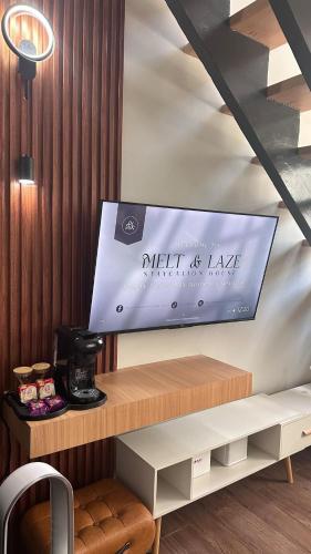 a table with a sign on the side of a room at Melt & Laze Cozy Stylish Aesthetic Relaxing House in San Pablo