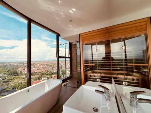 a bathroom with a tub and a sink and windows at Swanlake ecopark Hanoi-Calm homestay in Kim Quan