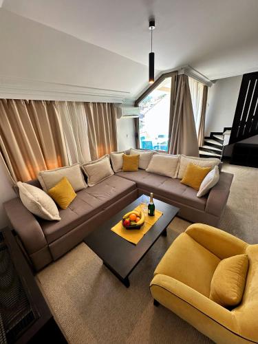 a living room with a brown couch and a table at Swiss Holiday in Budva