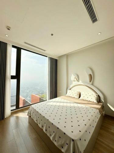 a bedroom with a large bed and a large window at Swanlake ecopark Hanoi-Calm homestay in Kim Quan