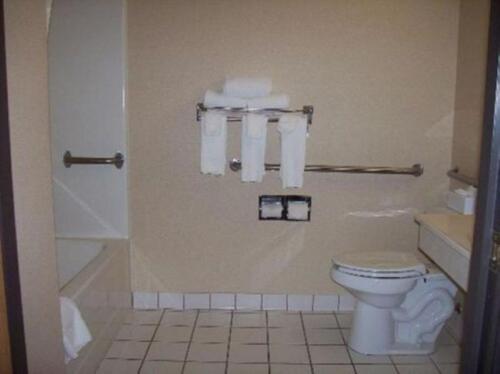a bathroom with a toilet and a shower and towels at Quality Inn & Suites Sioux City Southeast in Sioux City