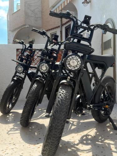 two dirt bikes parked next to a building at Fata Morgana Guest Rooms in Diamante