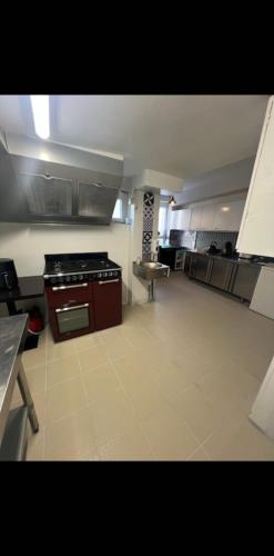 a large kitchen with a stove top oven in a room at Gite la Vieille Auberge de Chaumard in Chaumard