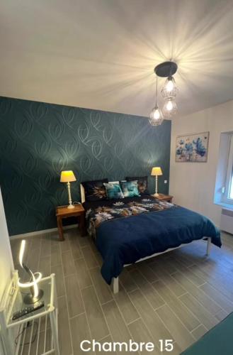 a bedroom with a blue bed and a green wall at Gite la Vieille Auberge de Chaumard in Chaumard