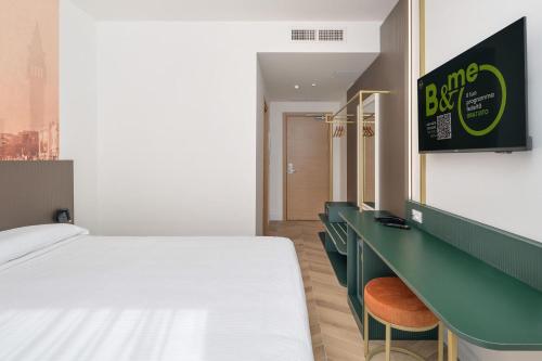 a hotel room with a bed and a desk at B&B HOTEL Venezia Laguna in Venice