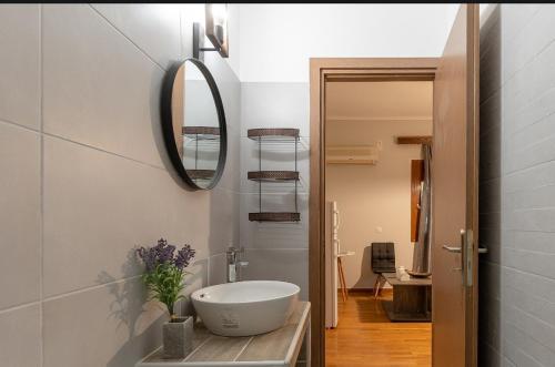 a bathroom with a sink and a mirror at Alice House 2 in Amarynthos