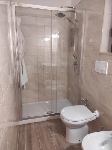 a bathroom with a shower and a toilet and a sink at Casa Vacanze Ogliarola in Manduria