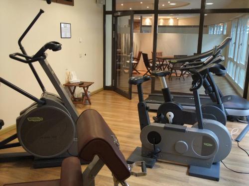 a gym with several exercise bikes in a room at Dorint Hotel am Dom Erfurt in Erfurt