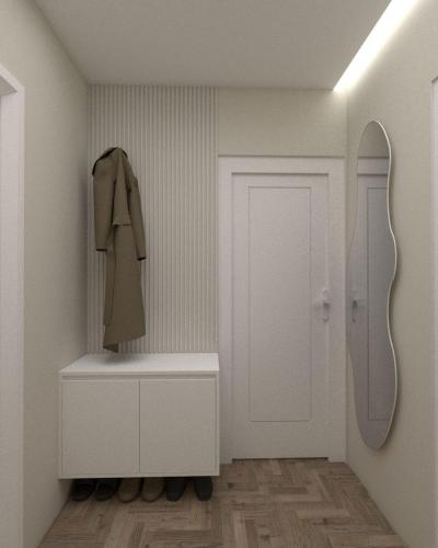 a hallway with a white door and a coat on a shelf at TAO Apartment 2 in Tirana