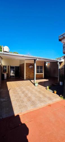 a house with a large patio in front of it at The Posadas House in Posadas
