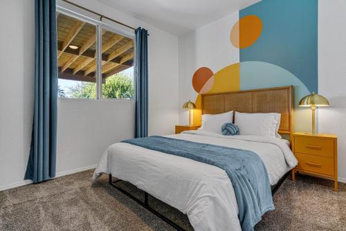 a bedroom with a large bed and a window at Colorful house with Amazing Backyard in Coachella