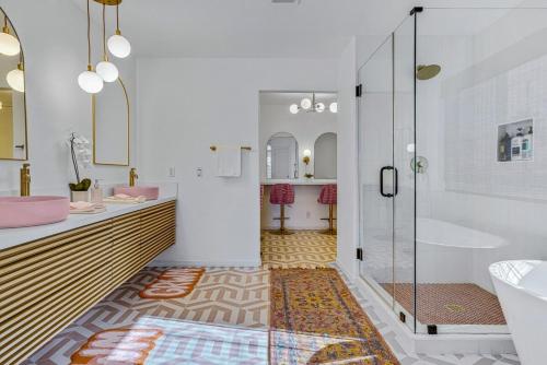 a bathroom with a shower and a sink and a tub at Colorful house with Amazing Backyard in Coachella