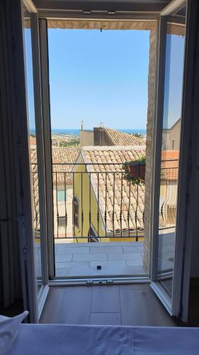 a room with a large window with a view of a building at Aghèl Luxury Room in Recanati