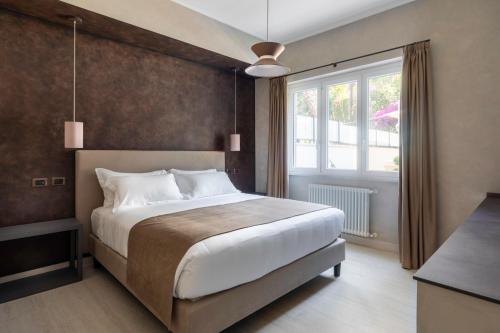 a bedroom with a large bed and a window at Pool & Spa Deluxe in Rome