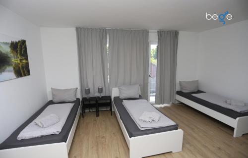 Ένα ή περισσότερα κρεβάτια σε δωμάτιο στο BEGE APARTMENTS ComfyStay