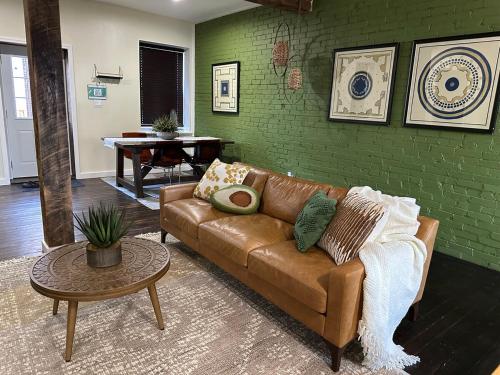 a living room with a couch and a table at Historic Carriage House Near Attractions in Saint Louis