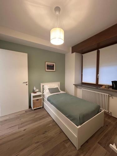 a bedroom with a large bed and a lamp at Stella Alpina in Paularo