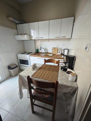 a small kitchen with a table and a sink at Cozy apartment in the city center in Katerini