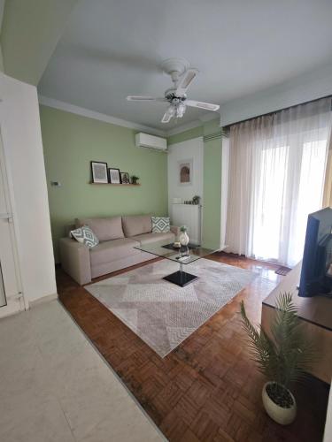 a living room with a couch and a table at Cozy apartment in the city center in Katerini