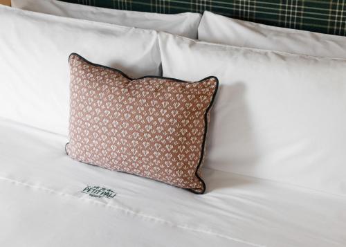 a pillow sitting on top of a white bed at Le Petit Pali St Helena in St. Helena