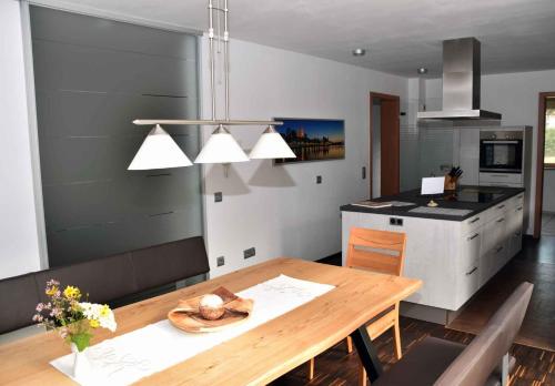 a kitchen with a wooden table and a dining room at Holiday home in Pfreimd - Oberpfalz 38096 in Pfreimd