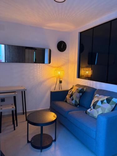a living room with a blue couch and a table at casa rural El Valle del Calar in Riópar