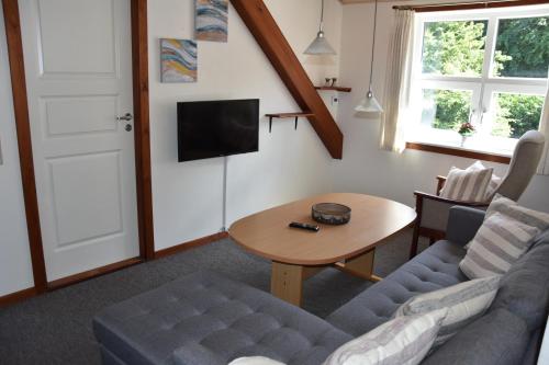 a living room with a couch and a table at City overnatning in Nørre Nebel