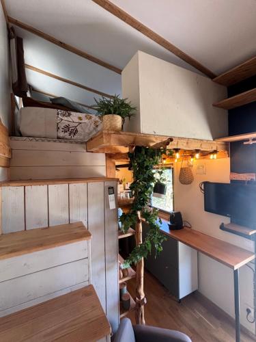 a tiny house with a kitchen and a desk at La Tiny du Luberon in Pertuis