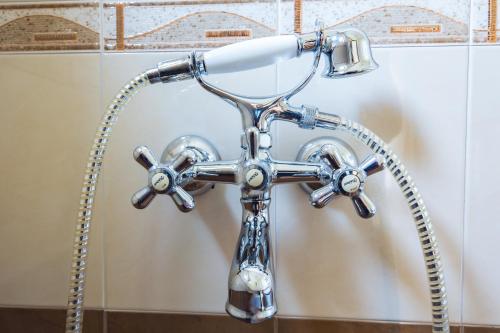 a chrome shower faucet in a bathroom at Hotel Albatros Old Town in Sozopol