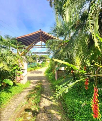 a dirt road with a bridge in the background at Mi Paraiso Escondido, Tamesis in Támesis