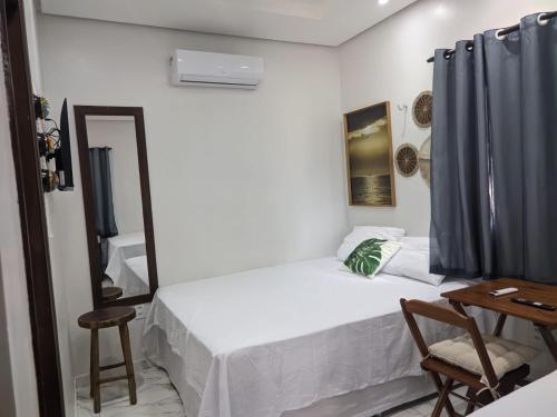 a small bedroom with a bed and a mirror at POUSADA NOSSO CANTO ALTER in Alter do Chao