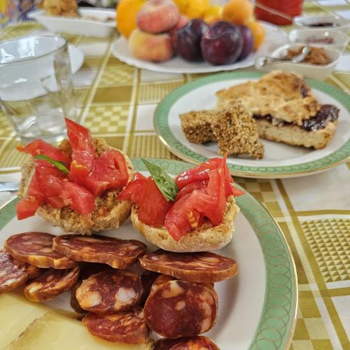 a table with two plates of sandwiches and other foods at L'oasi del raganello in Civita