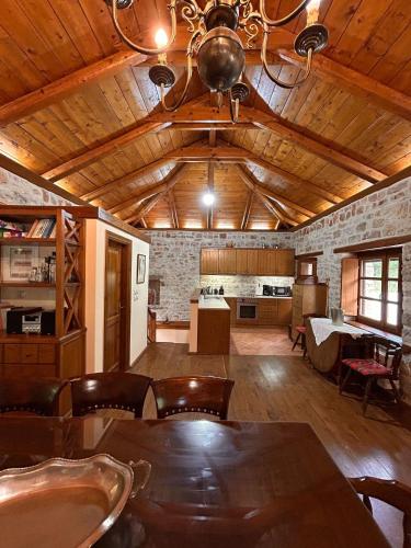 a dining room with a table and a ceiling at Villa Acroria in Karpenisi in Karpenision