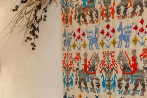 a tapestry hanging on a wall at Bixinau Camere Museo in Tortolì