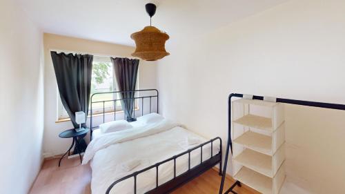 a bedroom with a bed and a window at Comfortable Living in a 3-Bedroom Space in Zürich