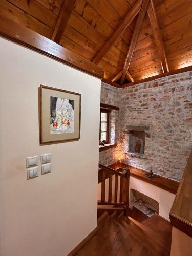 a room with a stone wall with a fireplace at Villa Acroria in Karpenisi in Karpenision