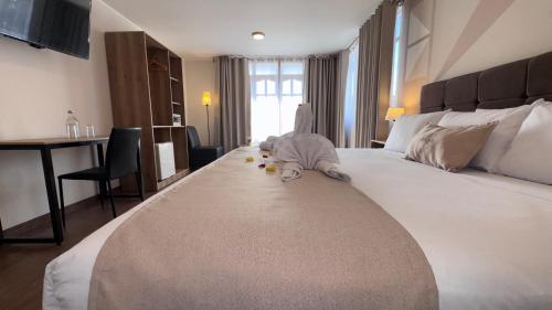 a bedroom with a large bed with a baby on it at Andari Hoteles in Arequipa