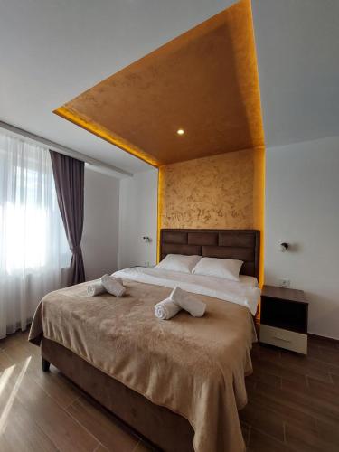 a bedroom with a large bed with two towels on it at Enigma Bajina Bašta in Bajina Bašta