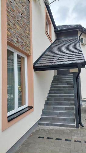 a staircase with an awning next to a building at Enigma Bajina Bašta in Bajina Bašta
