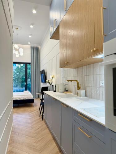 a kitchen with a sink and a counter top at ROOSEVELTA RESIDENCE Apartments - przy OFF Piotrkowska in Łódź